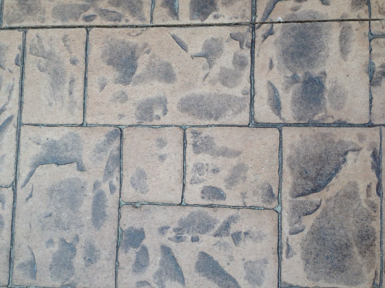 Close-up of stamped concrete showing an ashlar slate pattern with color variation